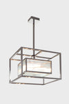 A contemporary stainless steel chandelier with clear ribbed glass shades, hanging from the ceiling.